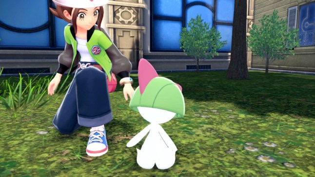 Pokemon trainer kneeling down besides a Ralts in Pokemon Legends ZA